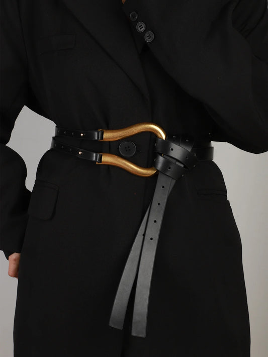 A woman's suit belt with a wide waistband large horseshoe button decoration with skirt belt